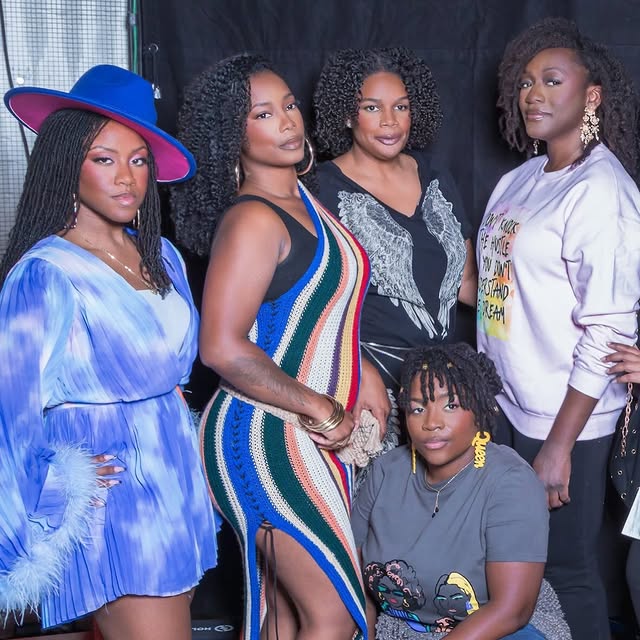 Five women with natural textured hairstyles posing at Texture Takes the Stage